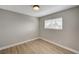 Cozy bedroom with wood-look floors, light grey walls, and a window with blinds for natural light at 2839 Boise St, Las Vegas, NV 89121