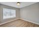 Bright bedroom with wood-look floors, natural light from the window, and fresh, light grey walls at 2839 Boise St, Las Vegas, NV 89121