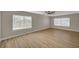 Spacious bedroom featuring wood flooring, fan, and large windows at 2839 Boise St, Las Vegas, NV 89121