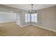 Dining area with hardwood floors, modern chandelier, and a view of the front door at 2839 Boise St, Las Vegas, NV 89121