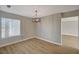 Dining area with hardwood floors, modern chandelier, and large window, perfect for entertaining at 2839 Boise St, Las Vegas, NV 89121