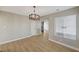 Dining room with hardwood floors, new chandelier, and a view to the living room at 2839 Boise St, Las Vegas, NV 89121