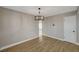 Dining area with hardwood floors, modern light fixture and an entrance to the hall at 2839 Boise St, Las Vegas, NV 89121