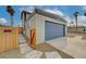 View of the two-car garage on a stucco home, accessed by a concrete driveway and adjacent to a gated yard at 2839 Boise St, Las Vegas, NV 89121