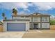 Inviting two-story home featuring a large garage, desert landscaping, and a covered front entryway at 2839 Boise St, Las Vegas, NV 89121