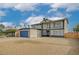 Two-story home featuring a large garage, desert landscaping, and a secure fenced yard at 2839 Boise St, Las Vegas, NV 89121