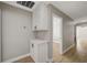 Hallway with wood-look flooring, cabinets and a doorway to a room with a ceiling fan at 2839 Boise St, Las Vegas, NV 89121