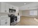 Modern kitchen features stainless steel appliances and white cabinets, flowing into the living room at 2839 Boise St, Las Vegas, NV 89121