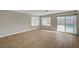 Living room featuring hardwood floors, large windows, and sliding door with a view of the pool at 2839 Boise St, Las Vegas, NV 89121