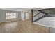 Spacious living room featuring new hardwood floors, large windows, and staircase at 2839 Boise St, Las Vegas, NV 89121