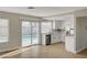 Open-concept kitchen with white cabinets, modern appliances, hardwood floors, and a view of the pool at 2839 Boise St, Las Vegas, NV 89121