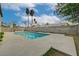 Large swimming pool with a concrete deck, surrounded by a block wall and mature trees at 2839 Boise St, Las Vegas, NV 89121