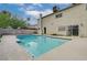 Backyard showcases a sparkling in-ground pool surrounded by concrete and a stucco home with a large chimney at 2839 Boise St, Las Vegas, NV 89121
