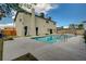 Backyard view features a sparkling pool with concrete surround and a neutral stucco two-story home at 2839 Boise St, Las Vegas, NV 89121