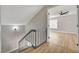 Bright stairwell featuring wood-look flooring and painted grey walls leading to another room with a ceiling fan at 2839 Boise St, Las Vegas, NV 89121