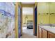 Bright bathroom featuring a charming beach-themed shower curtain and wood-look vanity at 3193 Emerald Creek Dr, Las Vegas, NV 89156