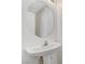 Bathroom featuring a modern round mirror and a white pedestal sink at 3193 Emerald Creek Dr, Las Vegas, NV 89156