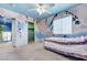 This charming bedroom features whimsical murals, a ceiling fan, and bright natural light at 3193 Emerald Creek Dr, Las Vegas, NV 89156