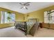 Bright bedroom with a ceiling fan, lush plants, and plenty of natural light at 3193 Emerald Creek Dr, Las Vegas, NV 89156