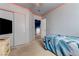 Comfortable bedroom with a wall mounted TV and sliding closet doors at 3193 Emerald Creek Dr, Las Vegas, NV 89156