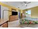 Bedroom with a large dresser, floral bedding, and a ceiling fan at 3193 Emerald Creek Dr, Las Vegas, NV 89156
