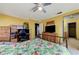 Bedroom with a desk, ceiling fan, and ample closet space, offering comfort and functionality at 3193 Emerald Creek Dr, Las Vegas, NV 89156