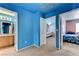 Bedroom with a view to the adjacent rooms with colorful walls and carpet flooring at 3193 Emerald Creek Dr, Las Vegas, NV 89156
