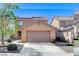 Two-story single-Gathering home with a two-car garage, solar panels, and low maintenance desert landscaping at 3193 Emerald Creek Dr, Las Vegas, NV 89156