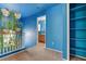 Hallway with blue walls, carpet flooring, white railing and a built-in shelving unit at 3193 Emerald Creek Dr, Las Vegas, NV 89156