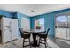 Kitchen with dining table and chairs and stainless steel refrigerator and lots of light at 3193 Emerald Creek Dr, Las Vegas, NV 89156