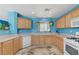 Spacious kitchen with white dishwasher and sink, laminate countertops, and hanging plants at 3193 Emerald Creek Dr, Las Vegas, NV 89156