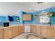 Spacious kitchen with white dishwasher and sink, laminate countertops, and hanging plants at 3193 Emerald Creek Dr, Las Vegas, NV 89156