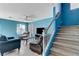 Cozy living room with blue walls, plush seating, and a staircase on the right at 3193 Emerald Creek Dr, Las Vegas, NV 89156