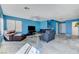 Bright living room with staircase, large window, and comfortable couches and chairs at 3193 Emerald Creek Dr, Las Vegas, NV 89156