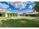 A large backyard with a pool, grassy area, and partial shade from mature trees at 3518 W Agate Ave, Las Vegas, NV 89139