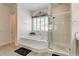 Stylish bathroom featuring a tub, a separate glass enclosed shower, and a window with shutters at 3518 W Agate Ave, Las Vegas, NV 89139