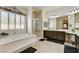 Inviting bathroom featuring a tub, separate glass enclosed shower, and double vanity sinks at 3518 W Agate Ave, Las Vegas, NV 89139