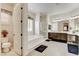 Bright bathroom featuring a tub, a separate glass enclosed shower, and double vanity sinks at 3518 W Agate Ave, Las Vegas, NV 89139