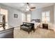 A cozy bedroom that features a ceiling fan, plantation shutters, and a comfortable bench at 3518 W Agate Ave, Las Vegas, NV 89139