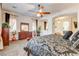 Comfortable bedroom with a ceiling fan, dresser, large windows, and access to a bathroom at 3518 W Agate Ave, Las Vegas, NV 89139