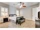 Charming bedroom featuring a ceiling fan, neutral tones, and a stylish dark wood bench at 3518 W Agate Ave, Las Vegas, NV 89139