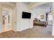 Bright bedroom with carpet, a wall-mounted TV and access to the main bedroom at 3518 W Agate Ave, Las Vegas, NV 89139