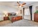 Traditional bedroom with a ceiling fan, dresser, bedside tables, and a large window at 3518 W Agate Ave, Las Vegas, NV 89139