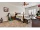 Cozy bedroom with carpet, ceiling fan and shutters; furnished with a king-sized bed, bedside tables, and decorations at 3518 W Agate Ave, Las Vegas, NV 89139