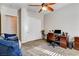 Bedroom showcasing a ceiling fan, closet, bathroom, a stylish workspace, and comfortable seating at 3518 W Agate Ave, Las Vegas, NV 89139