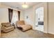 Bedroom featuring a sitting area and a view of ensuite bathroom at 3518 W Agate Ave, Las Vegas, NV 89139