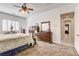 Bright bedroom with carpet, shutters, ceiling fan and is furnished with a king-sized bed, a dresser, and decor at 3518 W Agate Ave, Las Vegas, NV 89139