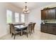 Dining area featuring table with seating, chandelier, and large windows at 3518 W Agate Ave, Las Vegas, NV 89139