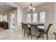 Dining area featuring table with seating, chandelier, and large windows at 3518 W Agate Ave, Las Vegas, NV 89139