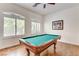 Charming game room features a billiard table with natural light from two windows at 3518 W Agate Ave, Las Vegas, NV 89139